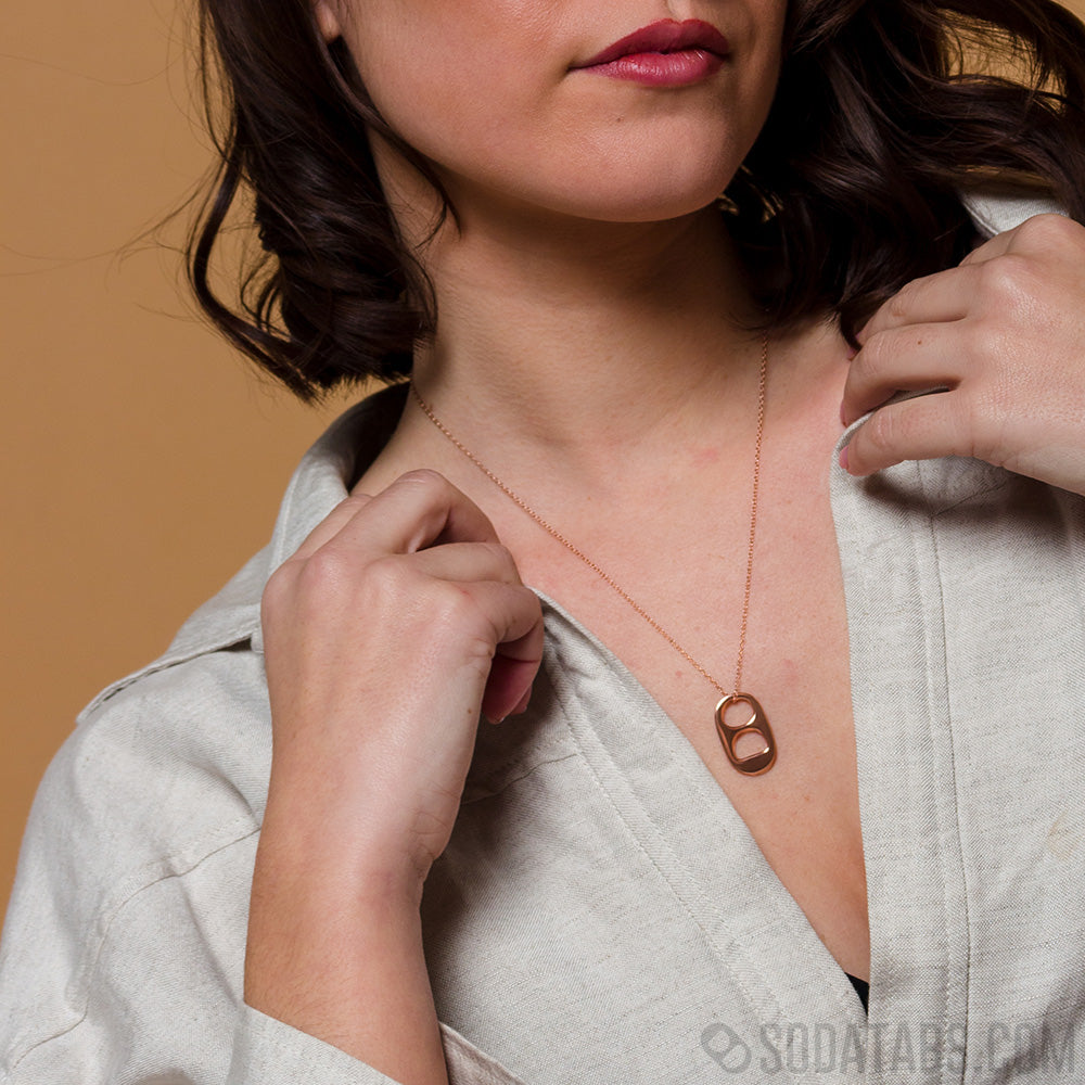 Woman wearing rose colored soda tab necklace