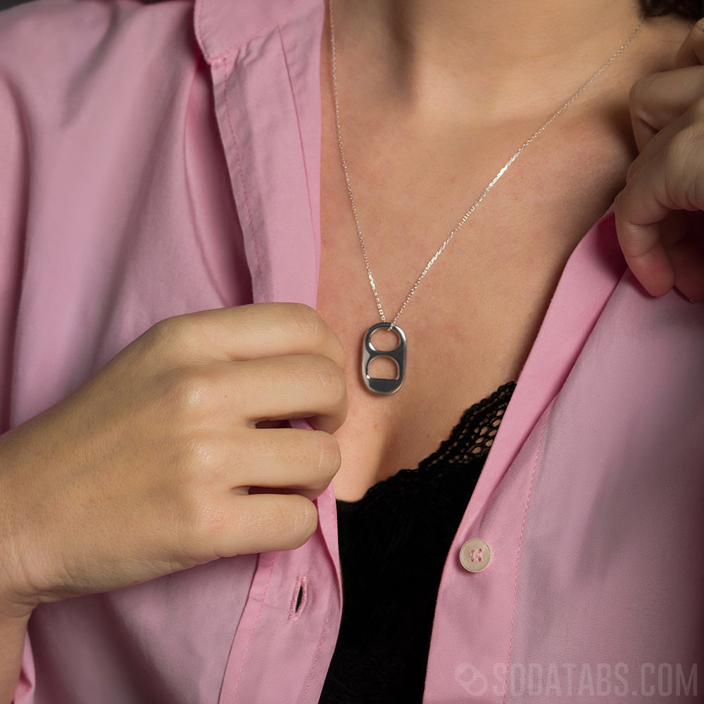 Up close shot of a silver Pop Tab pending on a matching silver chain